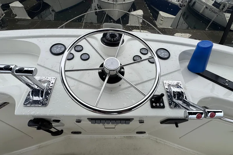Slide: The Image of Steering wheel and controls of a 1974 Tollycraft 40 Tri-Cabin MY boat. - 2