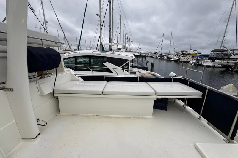 Slide: The Image of 1974 Tollycraft 40 Tri-Cabin MY at marina, overcast sky, spacious deck view. - 22