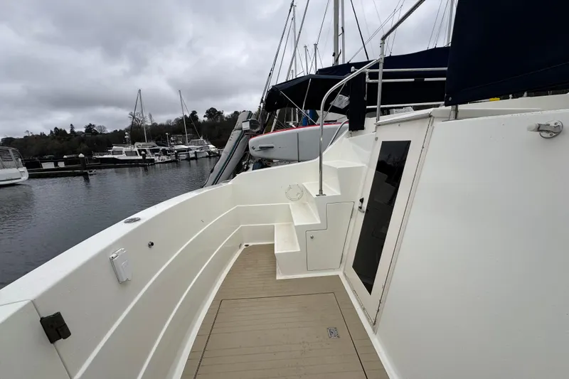 Slide: The Image of 1974 Tollycraft 40 Tri-Cabin MY yacht docked at marina under cloudy skies. - 23