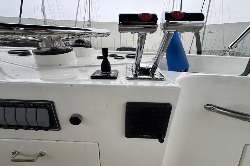 Slide: The Image of 1974 Tollycraft 40 Tri-Cabin MY helm controls with chrome levers and Garmin speaker. - 28