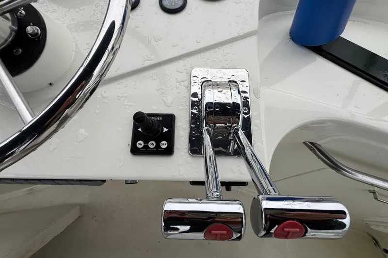 Slide: The Image of 1974 Tollycraft 40 Tri-Cabin MY helm controls with chrome levers and steering wheel. - 29