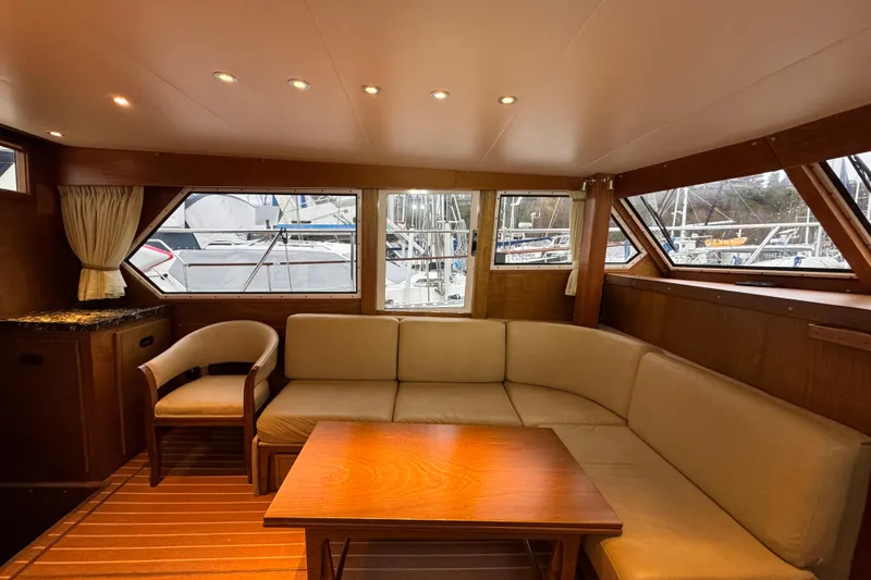 Slide: The Image of Cozy interior of 1974 Tollycraft 40 Tri-Cabin MY with beige seating and wooden accents. - 3
