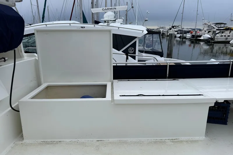 Slide: The Image of 1974 Tollycraft 40 Tri-Cabin MY boat deck with open storage compartment at marina. - 31