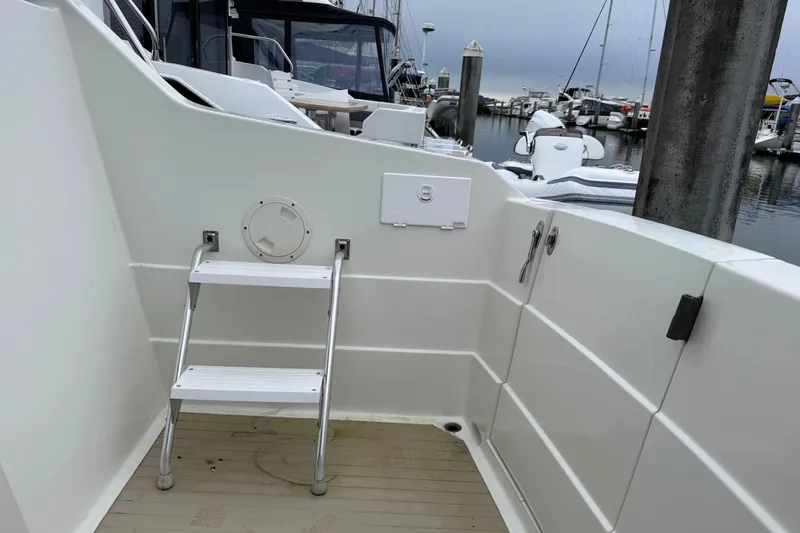 Slide: The Image of 1974 Tollycraft 40 Tri-Cabin MY boat deck with ladder at marina. - 32