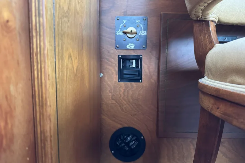 Slide: The Image of 1974 Tollycraft 40 Tri-Cabin MY interior with power control panel and wooden chair. - 39