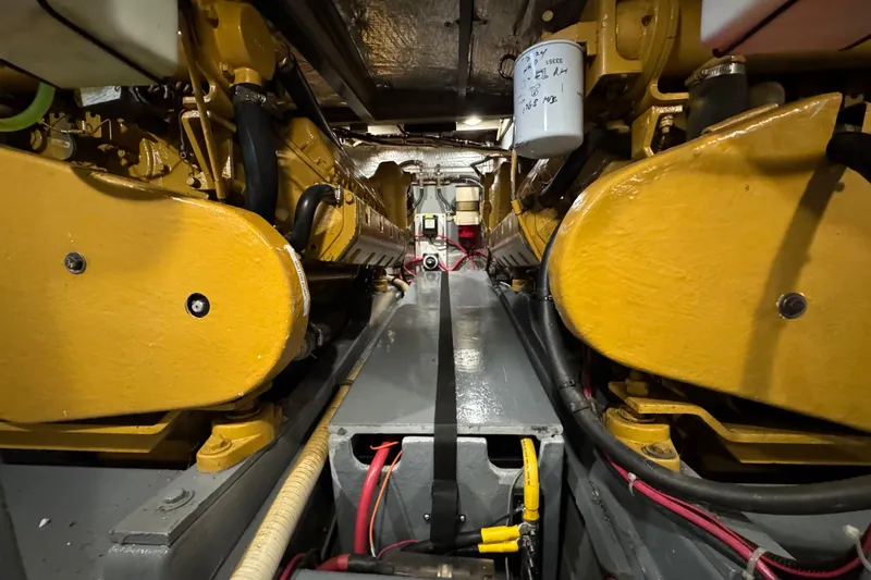 Slide: The Image of Engine room of 1974 Tollycraft 40 Tri-Cabin MY with yellow machinery and wiring. - 42