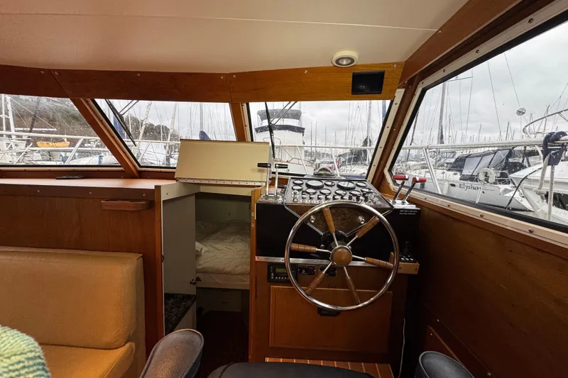 Slide: The Image of 1974 Tollycraft 40 Tri-Cabin MY helm with wooden interior and marina view. - 6