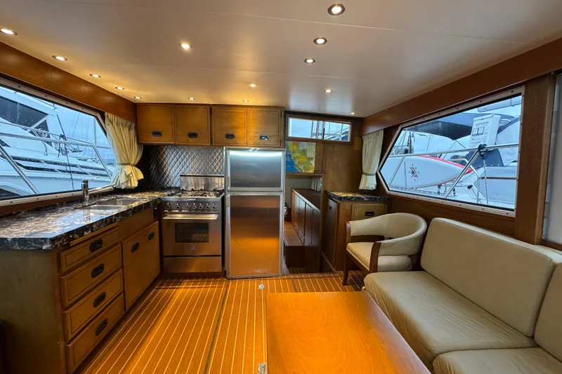 Slide: The Image of Interior of 1974 Tollycraft 40 Tri-Cabin MY yacht with modern kitchen and seating area. - 9