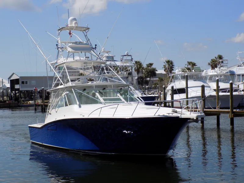 The Image of Cabo 45 Express 2000 in harbor, blue and white yacht. - 0