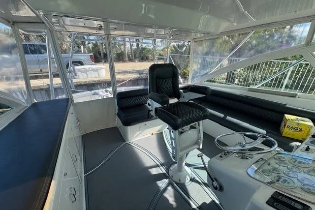 Slide: The Image of Interior of 2000 Cabo 45 Express boat with helm, seating, and controls. - 11