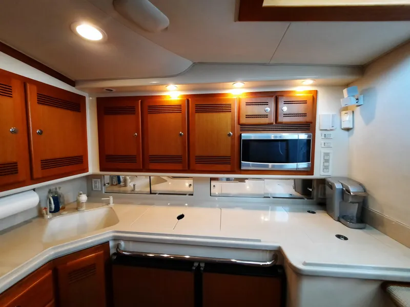 Slide: The Image of Interior of 2000 Cabo 45 Express with modern kitchen. - 23