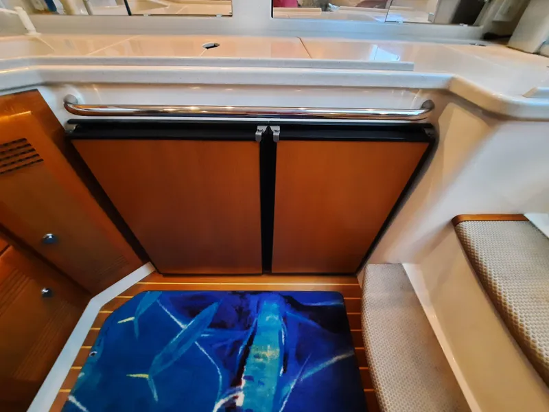 Slide: The Image of Interior of 2000 Cabo 45 Express yacht with marine-themed decor. - 25