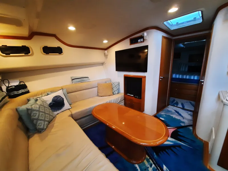 Slide: The Image of Interior of 2000 Cabo 45 Express yacht with cozy seating area. - 26