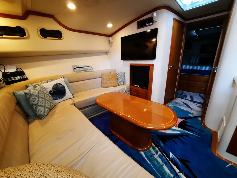 Slide: The Image of Interior of a 2000 Cabo 45 Express yacht with cozy seating area. - 27