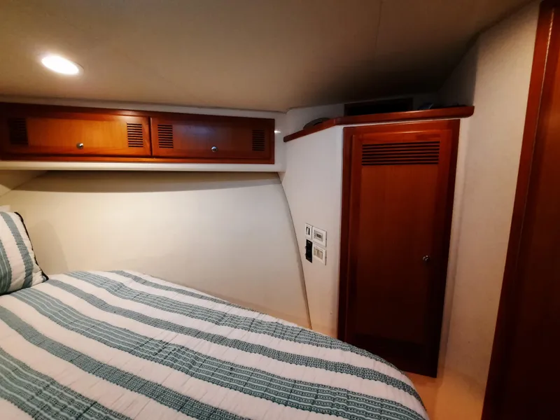 Slide: The Image of Interior of 2000 Cabo 45 Express with wooden cabinetry. - 31