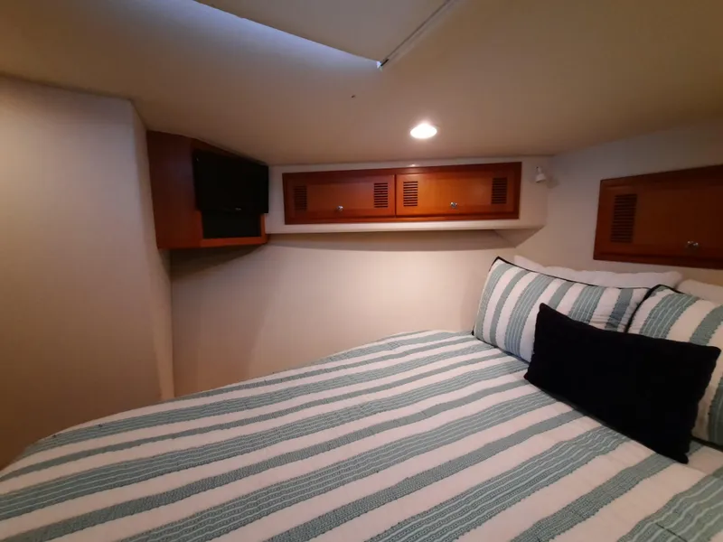 Slide: The Image of Interior of Cabo 45 Express 2000 with cozy bed. - 32