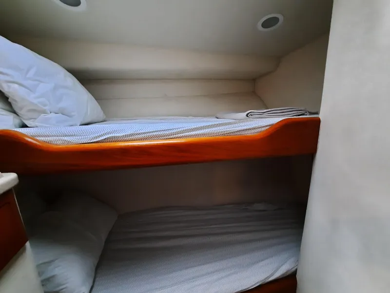 Slide: The Image of Interior of 2000 Cabo 45 Express with bunk beds. - 33