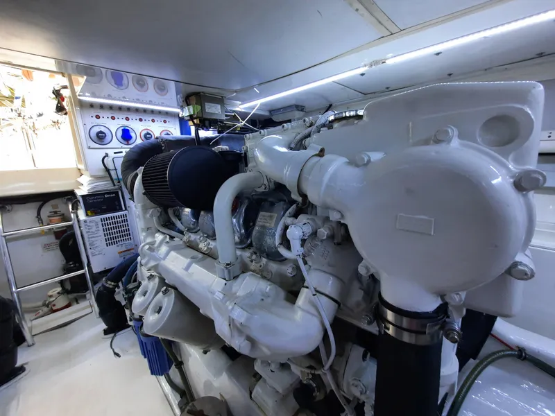 Slide: The Image of Engine room of 2000 Cabo 45 Express with white engine. - 42