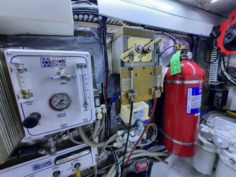 Slide: The Image of Engine room of 2000 Cabo 45 Express with fire extinguisher. - 46