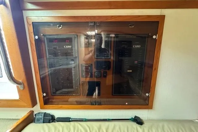 Slide: The Image of Electrical panel of a 2000 Cabo 45 Express boat, featuring control switches and meters. - 53