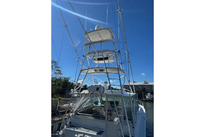 Slide: The Image of 2000 Cabo 45 Express boat with tall tower against clear blue sky. - 55