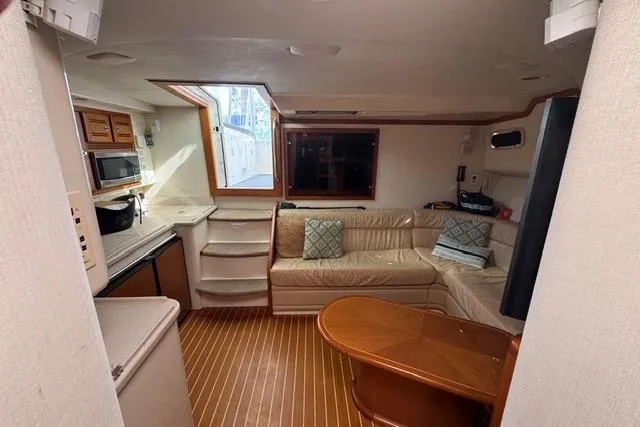 Slide: The Image of Interior of 2000 Cabo 45 Express yacht with cozy seating and kitchenette. - 56