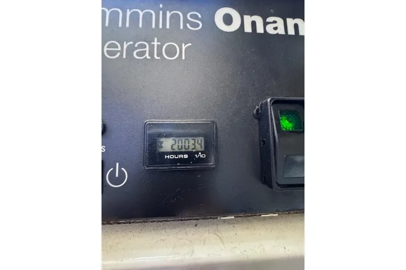 Slide: The Image of Cummins Onan generator panel showing 2003.9 hours on Cabo 45 Express, 2000 model. - 68