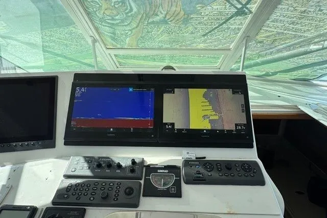 Slide: The Image of Control panel of a 2000 Cabo 45 Express boat with navigation screens. - 7