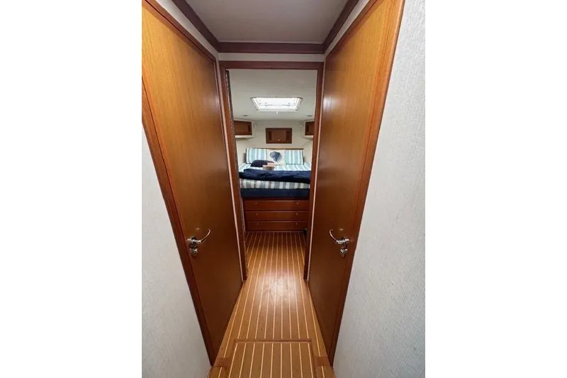 Slide: The Image of Interior view of 2000 Cabo 45 Express yacht cabin with wooden flooring and cozy bed. - 73