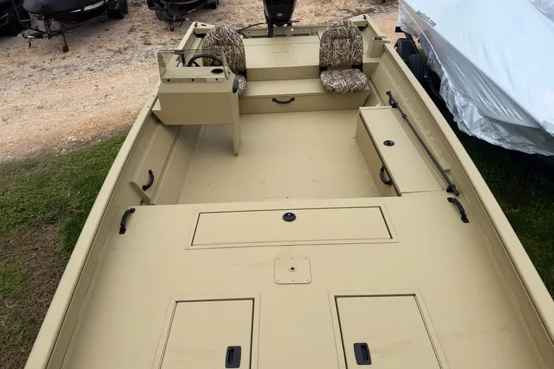 Slide: The Image of 2026 Lowe Roughneck 2070SC boat interior with camo seats and storage compartments. - 11