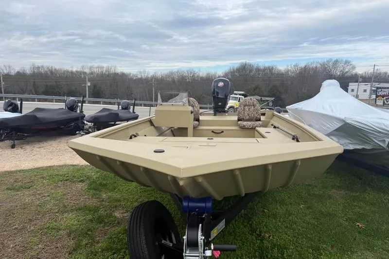 Slide: The Image of 2026 Lowe Roughneck 2070SC boat on trailer, outdoors, under cloudy sky. - 3