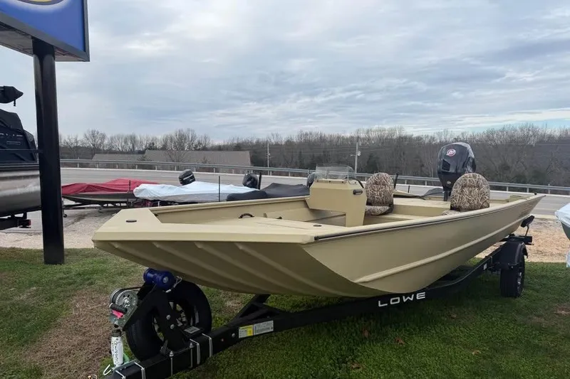 Slide: The Image of 2026 Lowe Roughneck 2070SC boat on trailer, parked outdoors under cloudy sky. - 4
