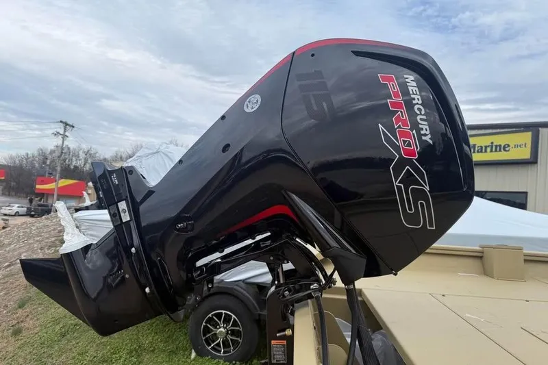 Slide: The Image of 2026 Lowe Roughneck 2070SC with Mercury Pro XS outboard motor, parked outdoors. - 6