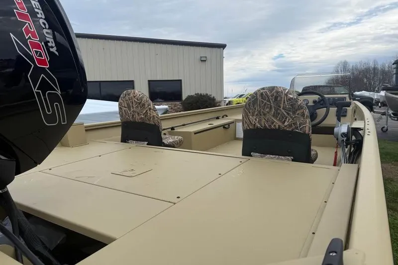 Slide: The Image of 2026 Lowe Roughneck 2070SC boat with camo seats and Mercury engine. - 7