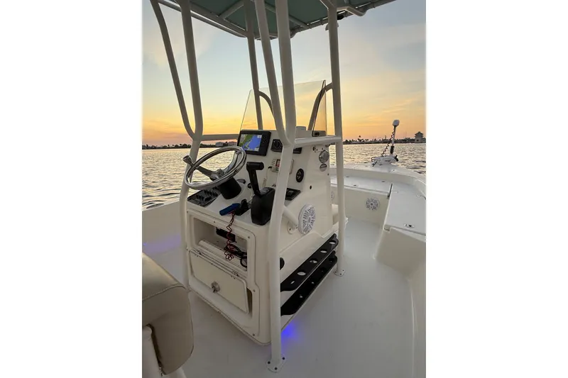 Slide: The Image of 2014 Pathfinder 2200 TRS boat interior at sunset on the water. - 13