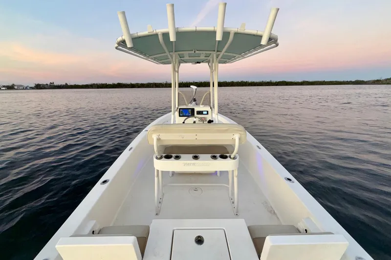 Slide: The Image of 2014 Pathfinder 2200 TRS boat on calm water at sunset. - 19