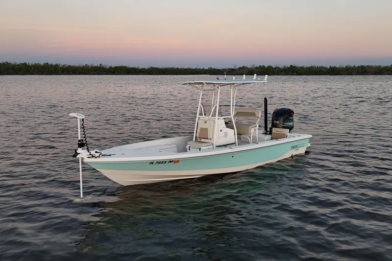 Slide: The Image of 2014 Pathfinder 2200 TRS boat on calm water at sunset. - 20