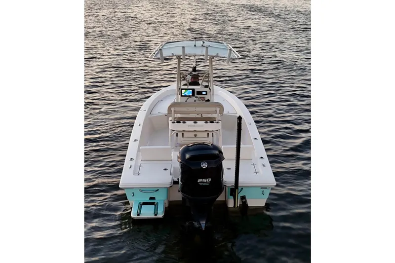 Slide: The Image of 2014 Pathfinder 2200 TRS boat on water, rear view with outboard motor. - 26