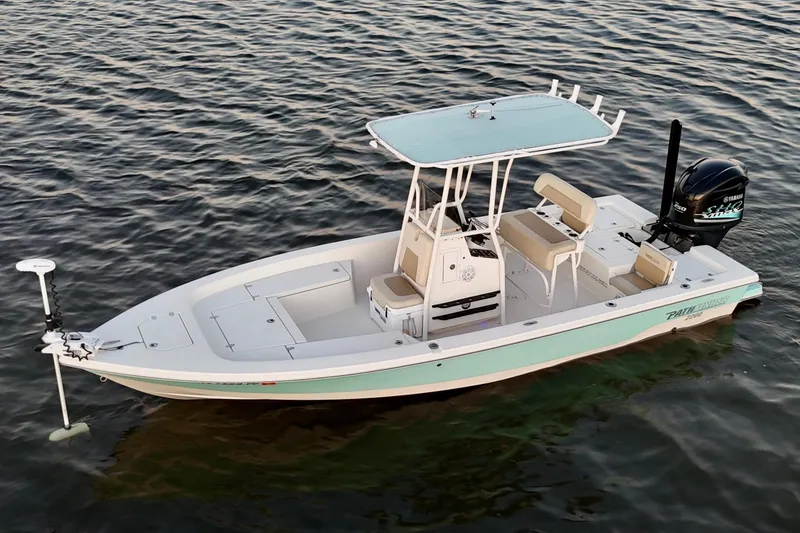 Slide: The Image of 2014 Pathfinder 2200 TRS boat on calm water, featuring a sleek design and modern amenities. - 27