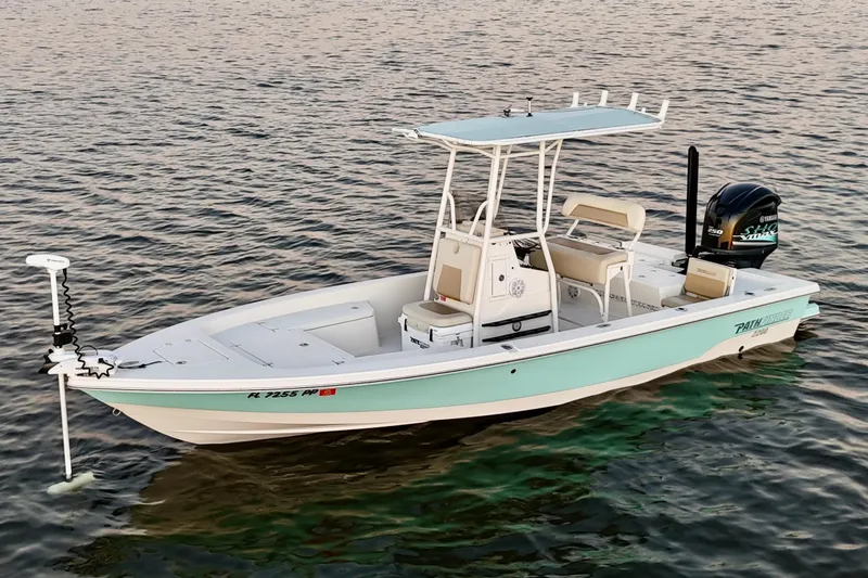Slide: The Image of 2014 Pathfinder 2200 TRS boat on calm water, featuring a sleek design and modern equipment. - 33