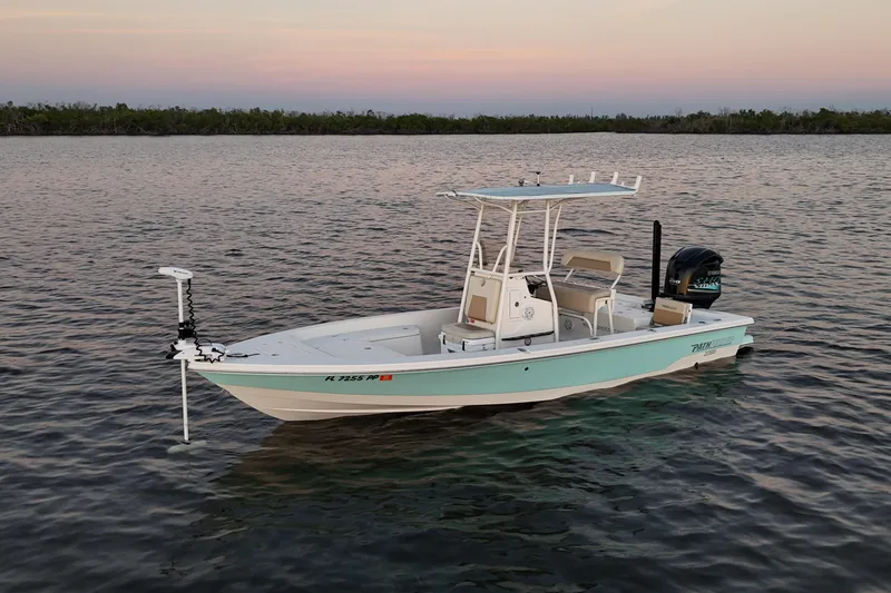 Slide: The Image of 2014 Pathfinder 2200 TRS boat on calm water at sunset. - 34