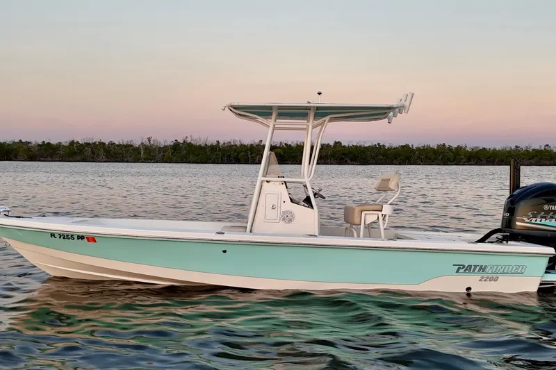 Slide: The Image of 2014 Pathfinder 2200 TRS boat on calm water at sunset. - 35