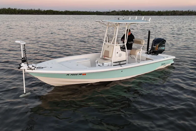 Slide: The Image of 2014 Pathfinder 2200 TRS boat on calm water at sunset. - 36