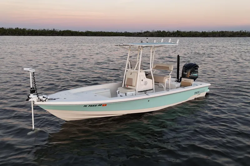 Slide: The Image of 2014 Pathfinder 2200 TRS boat on calm water at sunset. - 37