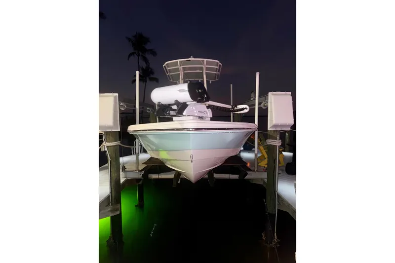 Slide: The Image of 2014 Pathfinder 2200 TRS boat docked at night with green underwater lights. - 4