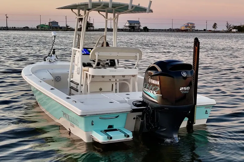 Slide: The Image of 2014 Pathfinder 2200 TRS boat with Yamaha engine on calm water at sunset. - 46