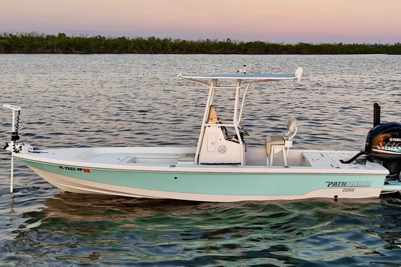 Slide: The Image of 2014 Pathfinder 2200 TRS boat on calm water at sunset. - 48