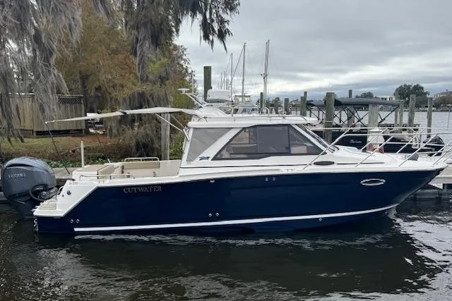 Slide: The Image of 2026 Cutwater C-248 Coupe boat on trailer, side view, under clear blue sky. - 0