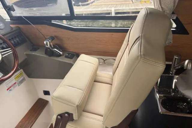 Slide: The Image of 2026 Cutwater C-248 Coupe boat docked by a scenic waterfront. - 10