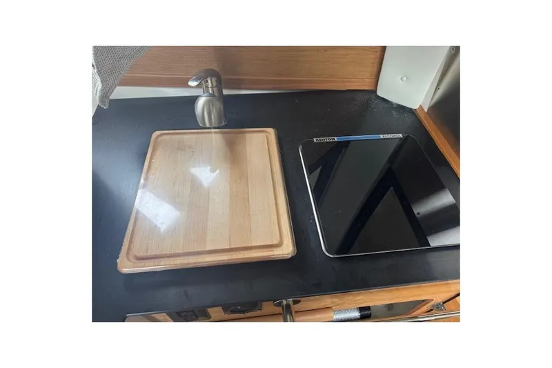 Slide: The Image of 2026 Cutwater C-248 Coupe interior with beige captain's chair and wooden accents. - 12